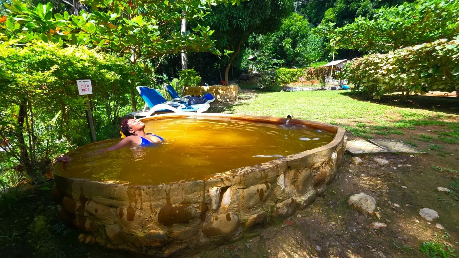 Guest relaxing in a natural sulphur hot spring pool
