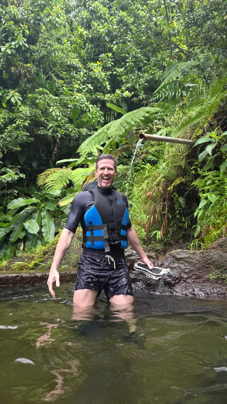 Guest beside a rainforest waterfall